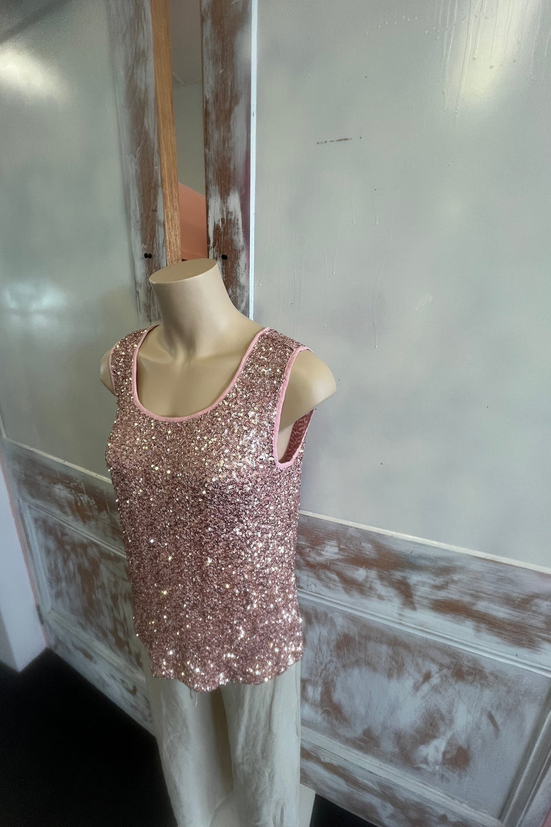 Pink glittery shoe on a mannequin foot against a neutral background
